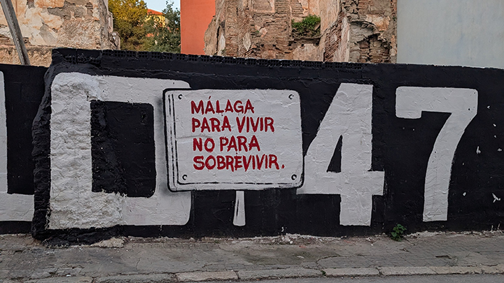 Mural on C. Coto de Doñana street translated in English, says: “Málaga to live, not just to survive.”